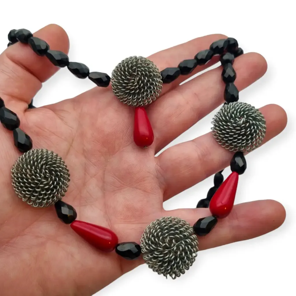 Art Deco choker necklace in black, red and silver with metallic pompoms.